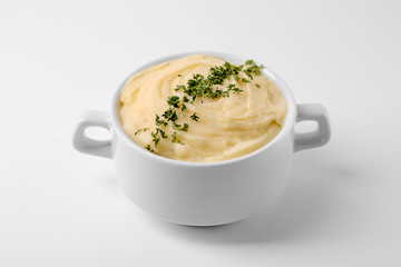 Dish with mashed potatoes on white background