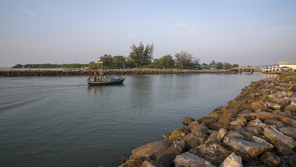 The fisherman is going back from the sea in the morning