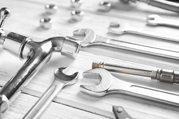 Plumber's tools on wooden background
