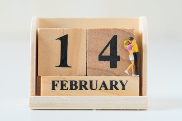 couple of miniature figure lover on wood cube calendar valentine day