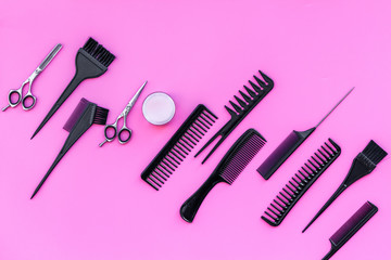 Beauty saloon equipment. Hairdress, haircut. Combs, sciccors, brushes on pink background top view copy space