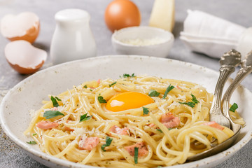 Pasta Carbonara. Spaghetti with bacon, egg, parsley and Parmesan cheese closeup. A traditional Italian dish. Selective focus