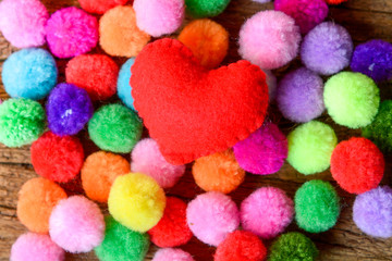 Fototapeta na wymiar Red Heart with colorful pom pom background, Valentine concept