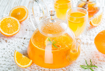 Tea made from sea buckthorn or cloudberries with orange and rosemary. Hot vitamin drink. Selective focus