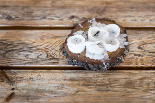 Burnt Candles With Melted Wax On A Wooden Table