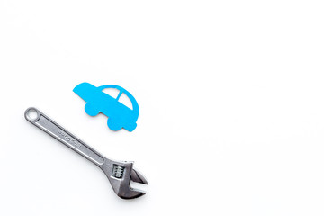 Car failures. Car service concept. Car silhouette and wrench on white backgound top view copy space