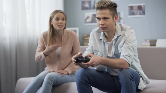 Upset sister shouting at playing games brother, lack of life communication