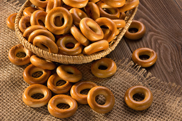 Small dry bagels on wooden table, top view.