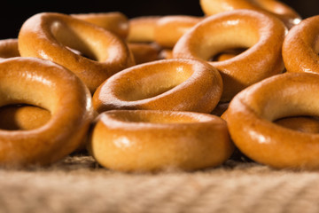 Small dry bagels on a wooden table, view from the side.