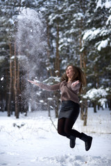 Beautiful woman blowing in the snow