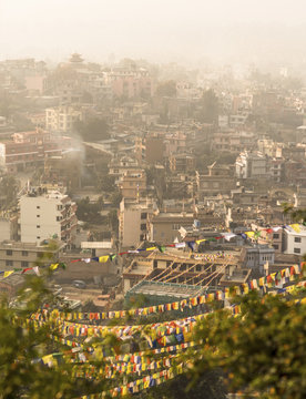Kathmandu city view and prayer flags after sunrise
