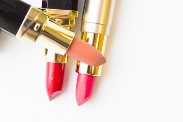 Make Up Beauty Fashion Concept. Matte red, pink and beige lipstick on white background, top view, flat lay