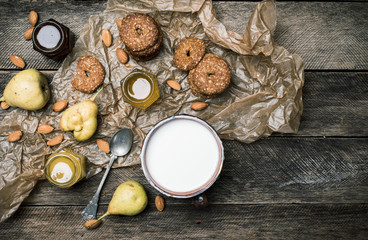 Obraz na płótnie Canvas Tasty Pears almonds Cookies and joghurt on rustic wood