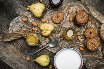 Fototapeta na wymiar Almonds pears Cookies and joghrut on wood boards