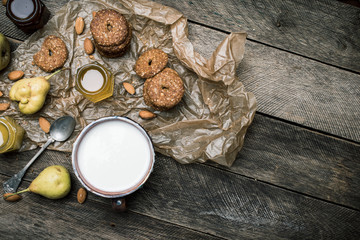 Tasty Pears almonds Cookies and joghurt on rustic wood