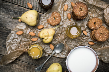Tasty Pears nuts Cookies and joghurt on rustic wood
