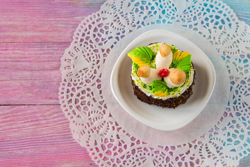 Tasty mini cake on a color gradient background