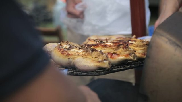 Halfs of chicken carcasses lies on grill and roasted