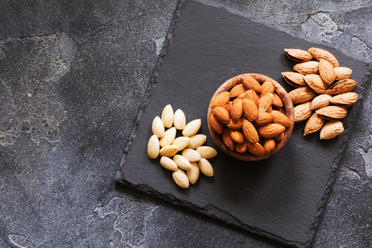 Three kind of almond: in shell, natural and peeled nut. Healthy food concept top view
