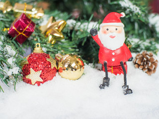 Santa claus doll and Red and glod christmas balls in the snow. Copy and paste for background, Concept decoration of christmas