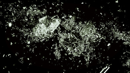 Pieces of splitted or cracked glass on black