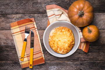 Rustic style pumpkins and flat cake on wooden table