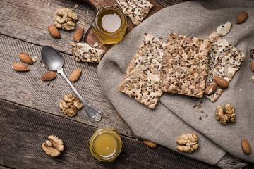 Fototapeta na wymiar Cookies with seeds, honey on napkin and wooden table