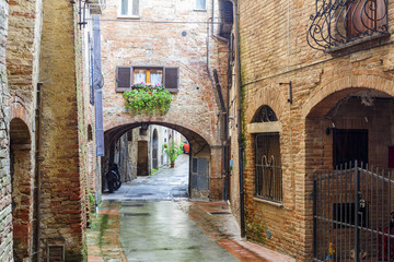 Back street in an old Italian town with iron gate