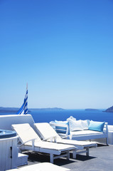 Fototapeta premium Traditional Greek architecture and a view of the blue sea over a white terrace. Santorini, Cyclades, Greece.