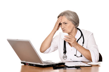 Woman doctor sitting with laptop