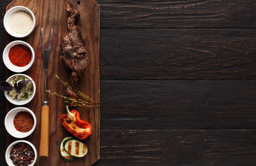 Grilled meat and vegetables on rustic wooden board