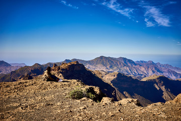 Looking at view of Canary Island Gran Canaria / Woman sitting on top of a mountain