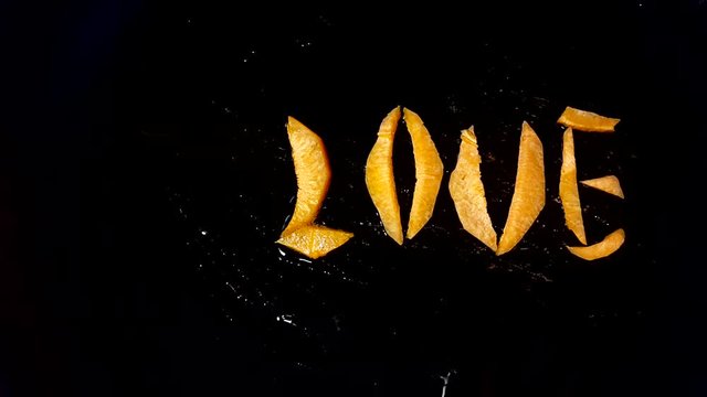 Fry carrots in the form of the word "love" in a frying pan
