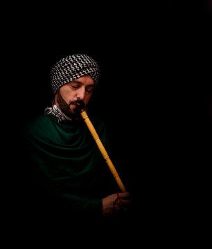 Muslim man with turban playing ney - Traditional sufi music