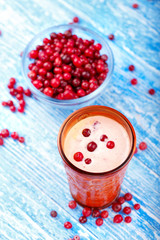 raw cranberries and milkshake on the table