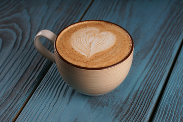 A cup of coffee on a wooden background