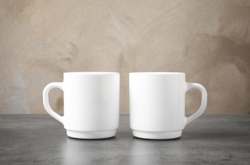 Ceramic cups on table. Mockup for design