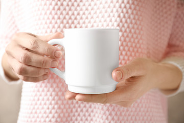 Woman holding ceramic cup, closeup. Mockup for design