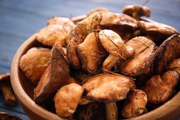 Bowl with forest mushrooms on table, closeup