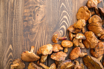 Raw forest mushrooms on wooden table