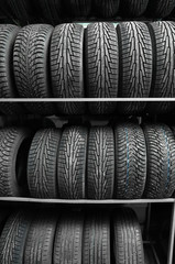 Rack with variety of car tires in automobile store