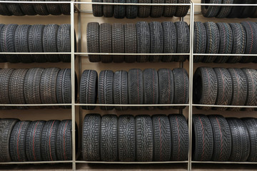 Rack with variety of car tires in automobile store