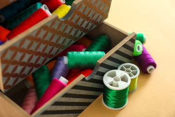 Drawers with sewing threads on color background