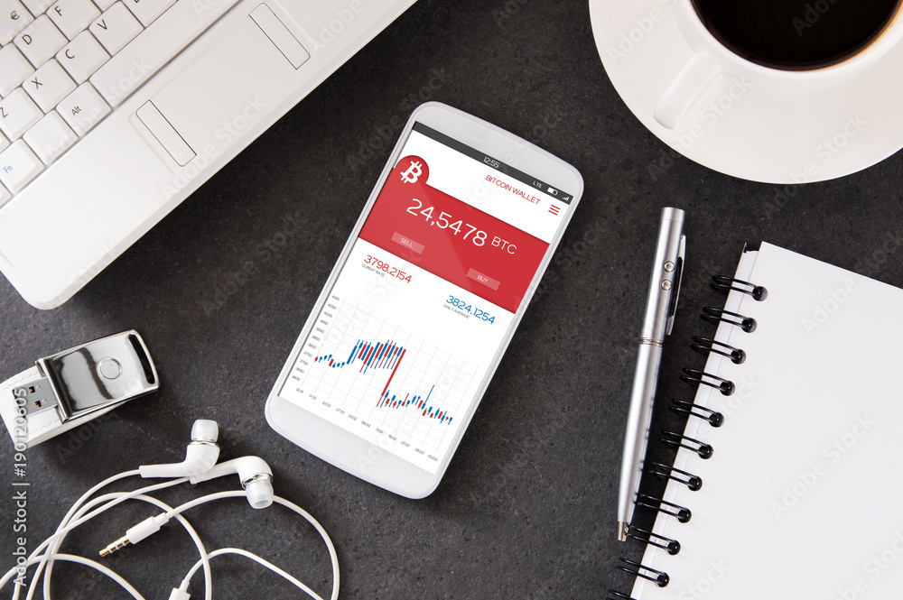 Poster smartphone is laying on the desk with forex application with bitcoin rates. interface created in gra