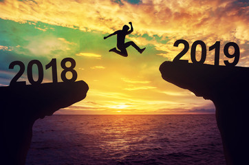 A man jump between 2018 and 2019 years. - obrazy, fototapety, plakaty