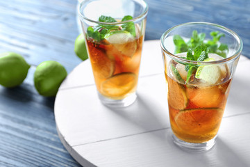 Glasses with Cuba Libre cocktail on wooden board