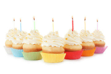 Birthday cupcakes with candles on white background