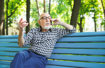 Fototapeta premium Senior man with mobile outdoors