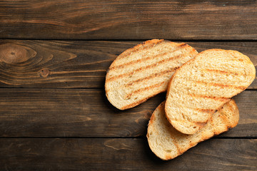 Toasted bread on wooden background