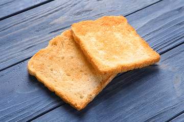 Toasted bread on wooden background
